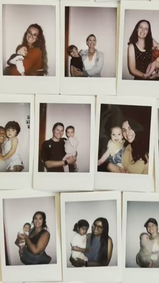 Polaroid wall of Mothering Club moms and kids